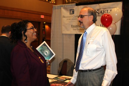 Gayle Warren of LegalShield, chats with Dunwoody closing attorney Larry Feldman at the Feldman Law Offices booth at the Greater Perimeter Business Expo on May 2.