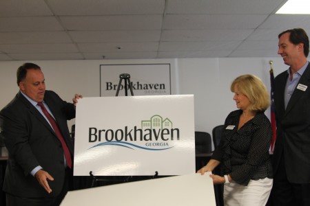 Left to right: Brookhaven Mayor J. Max Davis and City Council members Rebecca Chase Williams and Bates Mattison reveal the city's new logo at a press conference at Brookhaven Municipal Court Aug. 29.