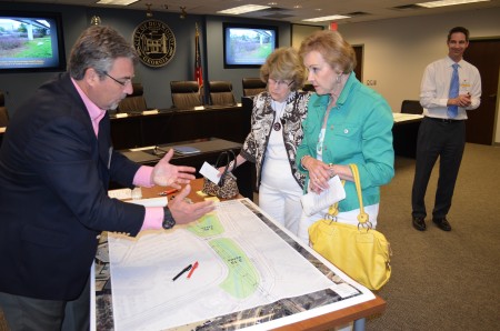 Consultant Ray Strychalski, left, discusses possible features of a proposed 5-acre Perimeter Park @ Dunwoody MARTA Station withDunwoody residents Jan Slater, center,  and Charlene Thurman, right, during a public meeting April 22 at Dunwoody City Hall. 