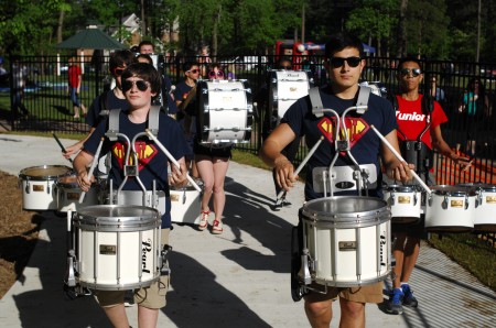 Josh Palgon, left, and Lance Kennedy lead the Dunwoody High School marching band as its marches through Brook Run Park on May 1 during the first Dunwoody Food Truck Thursday of the summer. 