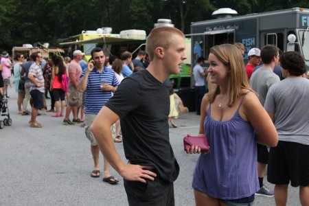 Kristen DeVos of Dunwoody and Jacob Clawson of Jacksonville, Fa., check the offerings of the food trucks gathered at Brook Run Park for Food Truck Thursday on June 19.