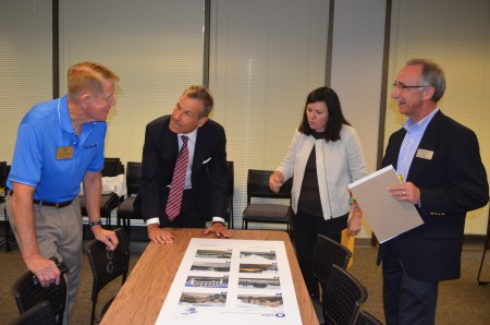 Left to right, Dunwoody City Councilman Denny Shortal, consultants Kirk Bishop and Leslie Oberholtzer, and Dunwoody Community Development Director Steve Foote examine photos of development styles during the kickoff meeting Sept. 4 of a effort to develop separate city zoning regulations for the Perimeter area in Dunwoody.