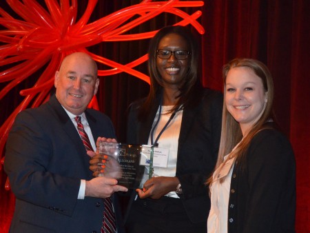 New BBA president Greg Davis, at left, presents Legoland general manager Penda Meftah, center, and marketing manager Whitney Wilson, at right, with the award fpr the organization's 'Business of the Year.' Davis presented the award during the BBA's annual luncheon on Jan. 22.