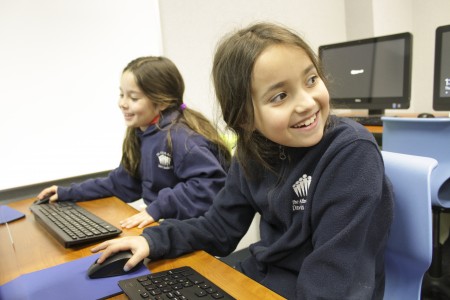 The Davis Academy was one of many local schools partipating in the week-long “Hour of Code” program, designed to encourage students to learn computer code. Zoe Nowak, in foreground, and Caylee Arron await instructions. 