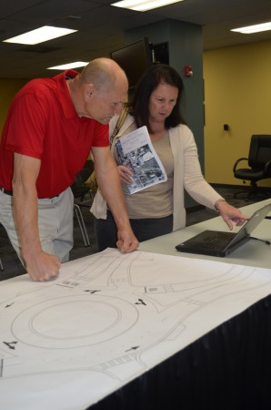 John and Donna Bendik check drawings and a computer animation showing how the proposed roundabouts would handle traffic.