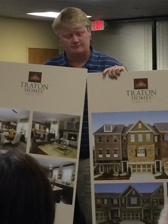 Clif Poston of Traton Homes shows proposed townhome designs to community members during a zoning meeting April 28. 