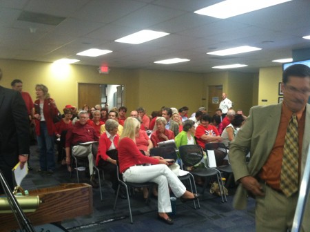 Ashton Woods opponents, wearing red as symbolic protest, crowd into the Sandy Springs City Council chamber Aug. 18.