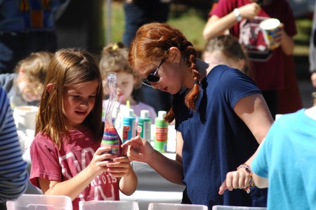 Apple Valley Road, next to Brookhaven MARTA Rail Station; Brookhaven Arts Festival; Saturday October 17, 2015 1:00pm. Making "Sand Art" Ella Kate McCord (8yr), and Jules schmidt (10yr) [glasses].
