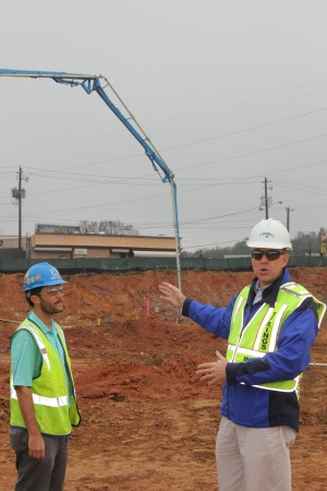 City Manager John McDonough (right) gestures to the performing arts center construction area at City Springs on Dec. 11 as Holder Construction project manager Hayes Todd looks on. (Photo: John Ruch)