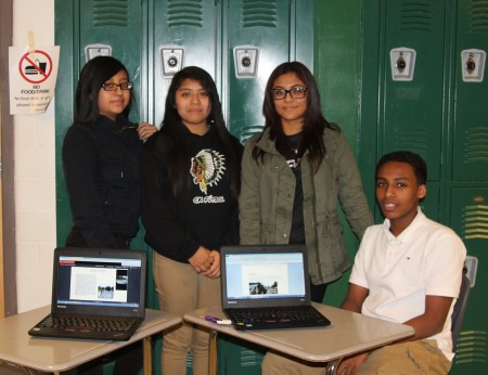 From left, Cross Keys students Dinamis Roblero-Lopez, Cindy Ramirez, Zujey Ramirez and Faysal Ando gather around laptops displaying their Buford Highway presentations. (Photo John Ruch)