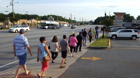 "Bus crawl" attendees walk on Buford Highway in Doraville on April 27. (Photo John Ruch)
