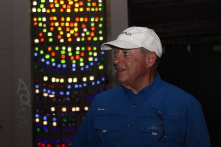 Danny Ross stands in front of historic stained glass in the chapel of the former Georgia Retardation Center. Ross envisions it as a place to hold weddings or catered events with the renovation of the building in Brook Run Park. (Photo Dyana Bagby)