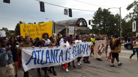 The protest march begins on Lenox Road from the Lenox MARTA Station. (Photo John Ruch)