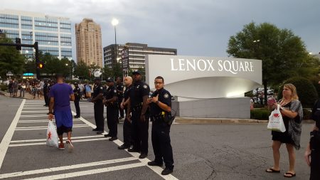 Police guard the mall. (Photo John Ruch)