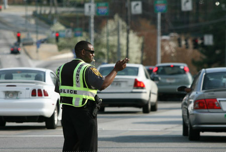 An off-duty DeKalb County Police officer hired for traffic control by the Perimeter Community Improvement Districts in a photo featured on the PCIDs website.