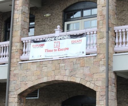 A sign declaring Time to Escape is open was hung in July before the city's request to a judge about the property's zoning put the entertainment business in limbo. (Photo Dyana Bagby)