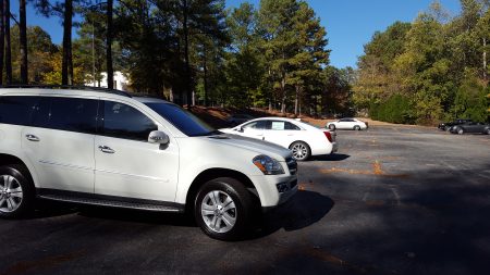 Cars stored in the lot rented by Classic Cadillac and Subaru at the North Fulton County Government Services Center on Roswell Road on Oct. 23. (Photo John Ruch)