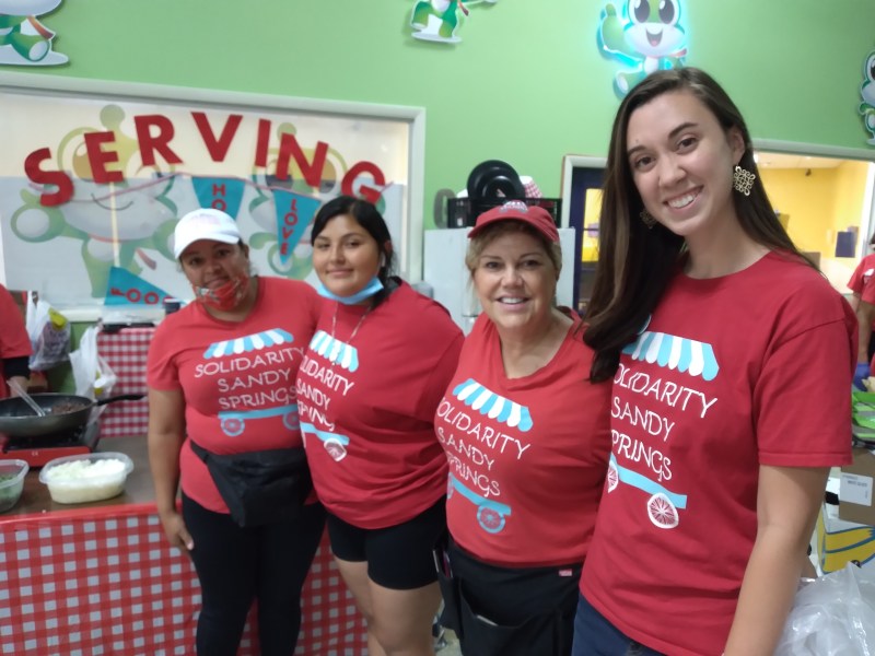 Realtor Jennifer Barns founded Solidarity Sandy Springs, which has opened a food pantry at 5920 Roswell Road, Suite B-116. From left, Maria Bravo, Ashley Olague, Jennifer Barnes and Abbey Mixon. (Photos by Amy Arno)