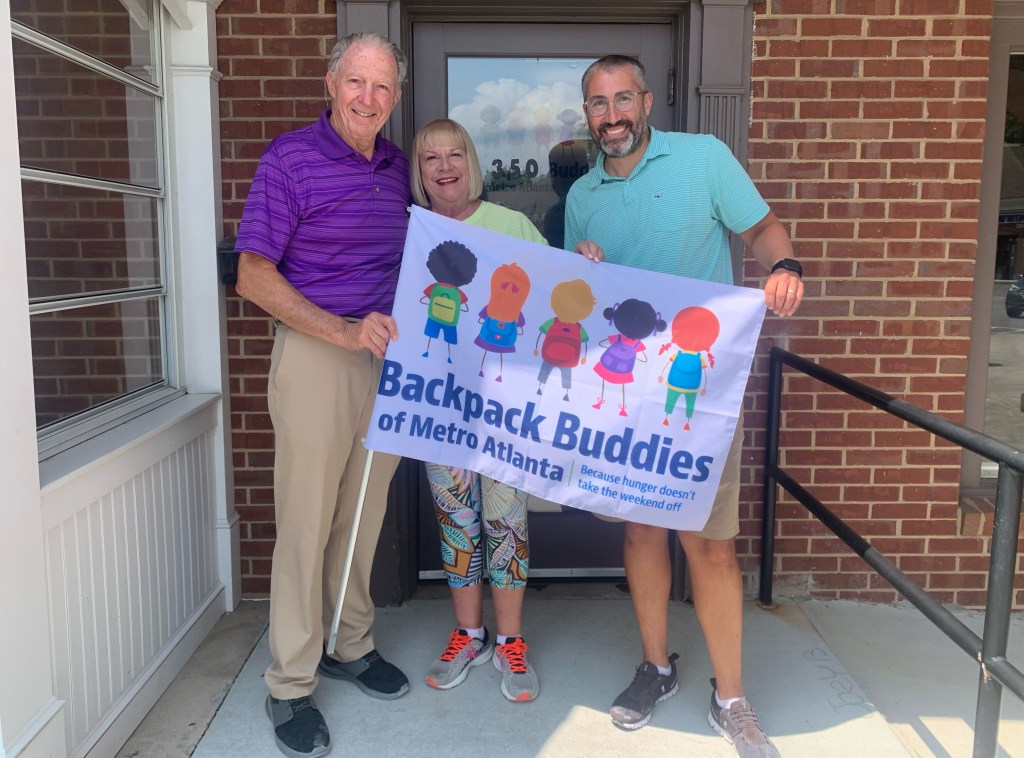 Backpack buddies team in front of their new facility 