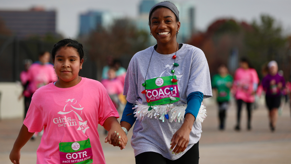 A volunteer and a participant in the Girls on the Run program