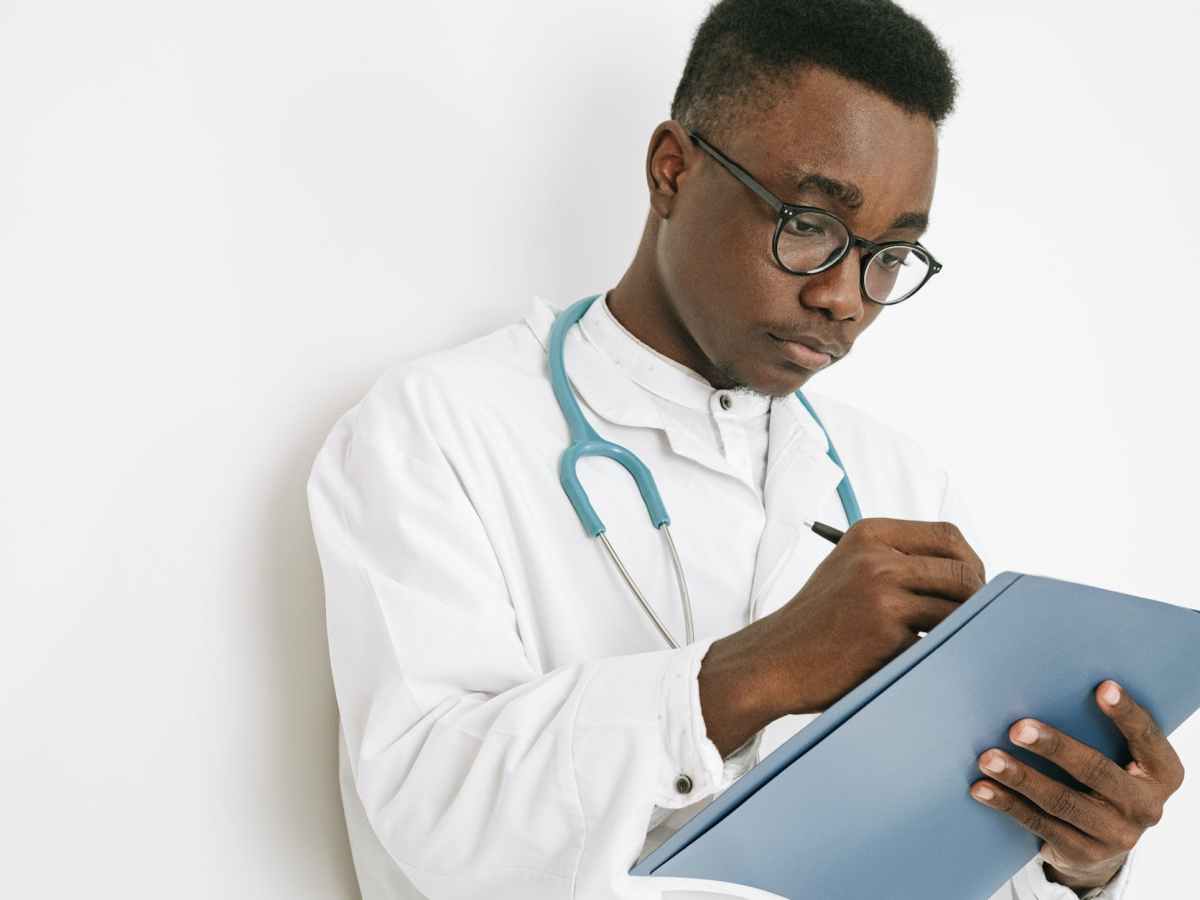 a doctor writing on a folder