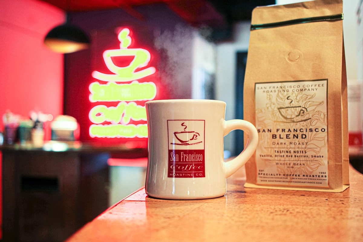 A picture of a coffee cup and a packet of coffee from the San Francisco Coffee Roasting Company.