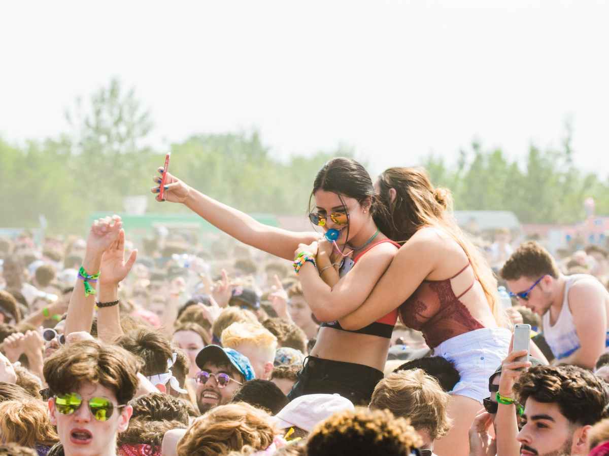 two women embracing surrounded by crowd
