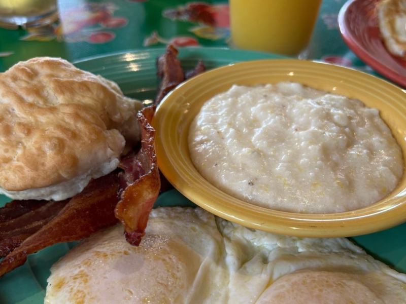 A biscuit, grits, bacon, and eggs from The Flying Biscuit Café.