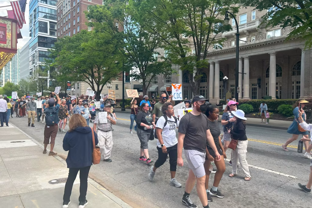 Protesters march in Atlanta against federal funding cuts, including those targeting the Centers for Disease Control and Prevention on Saturday.
